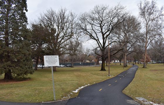 A paved path curving through a Boise park beside bare winter trees