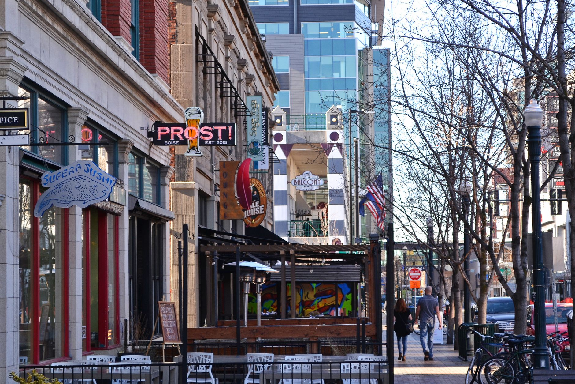 Lively downtown Boise street with shops, signage, and pedestrians enjoying a sunny day, illustrating How Boise Is Laid Out, and Which Way Its Streets Run