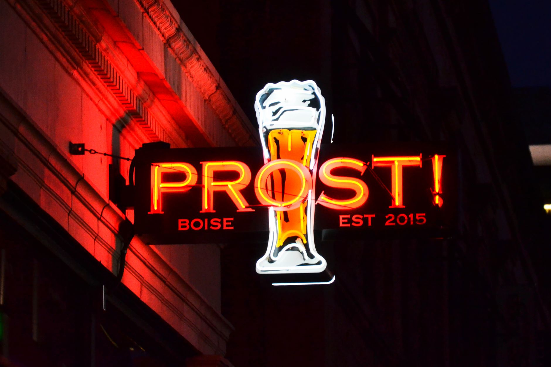Vibrant neon sign of a beer glass in Boise, glowing against a night backdrop, illustrating What Is the Difference Between Boise, Meridian and Eagle