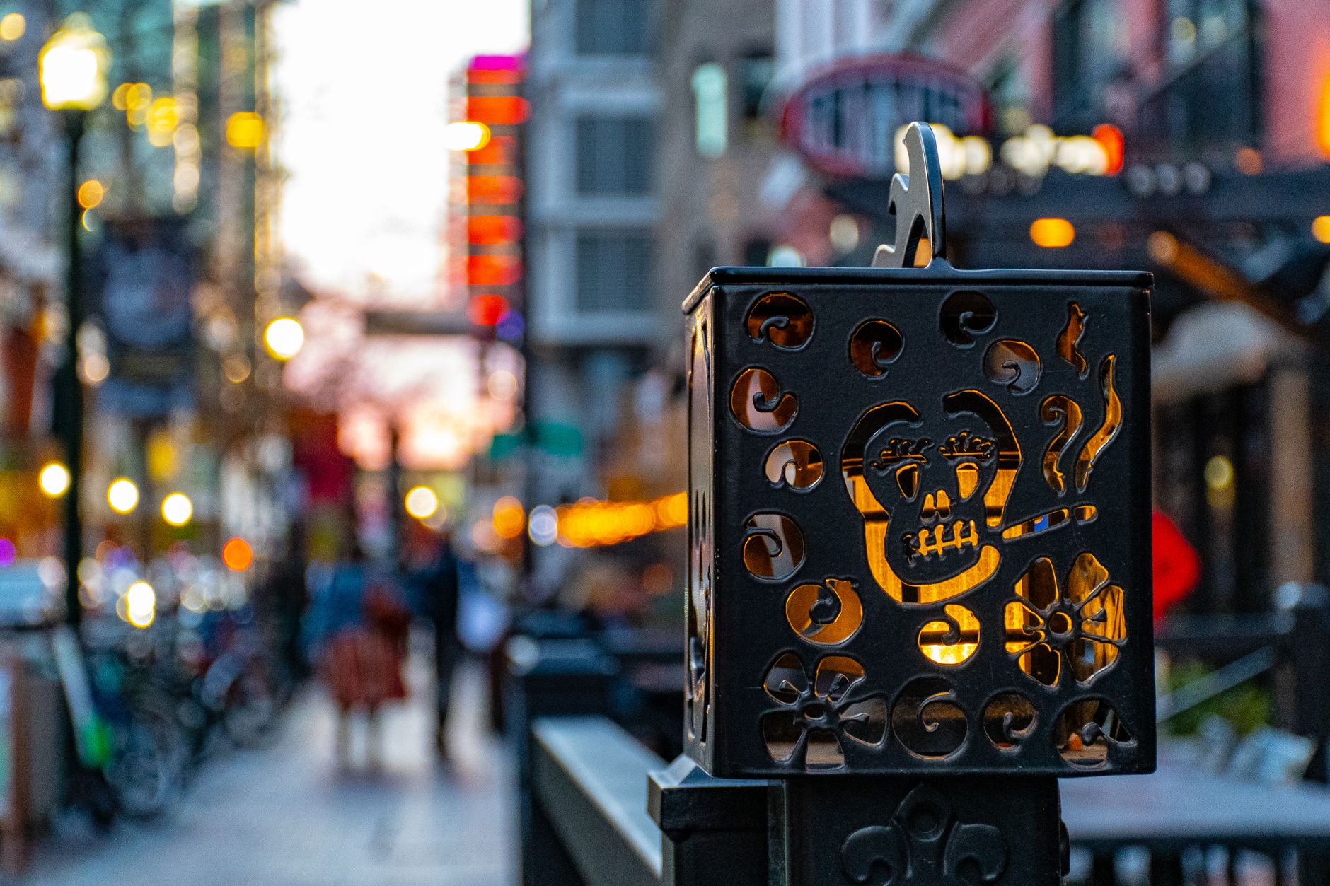 A decorative street lantern featuring a skull design in downtown Boise, Idaho at dusk, illustrating Getting From Boise to Bogus Basin Without a Car