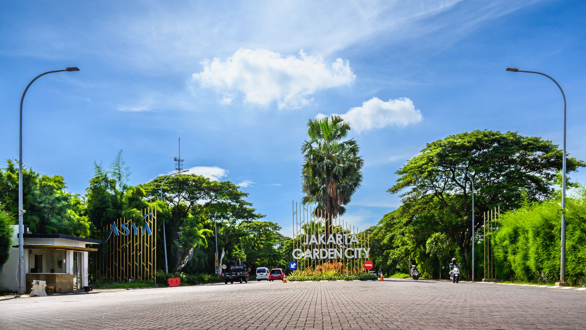 View of the Jakarta Garden City entrance surrounded by lush greenery under a bright blue sky, illustrating What Is Garden City, Idaho, and Why Is It a Separate City