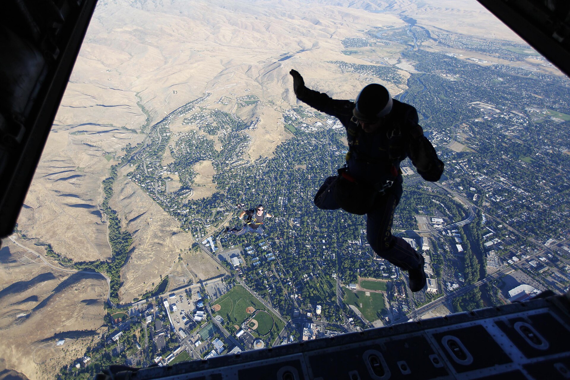 US Navy N 0000W Members of the U.S. Navy parachute demonstration team, the Leap Frogs, jump out of a Kentucky Air National Guard C H2 Hercules aircraft above the Idaho State Capito