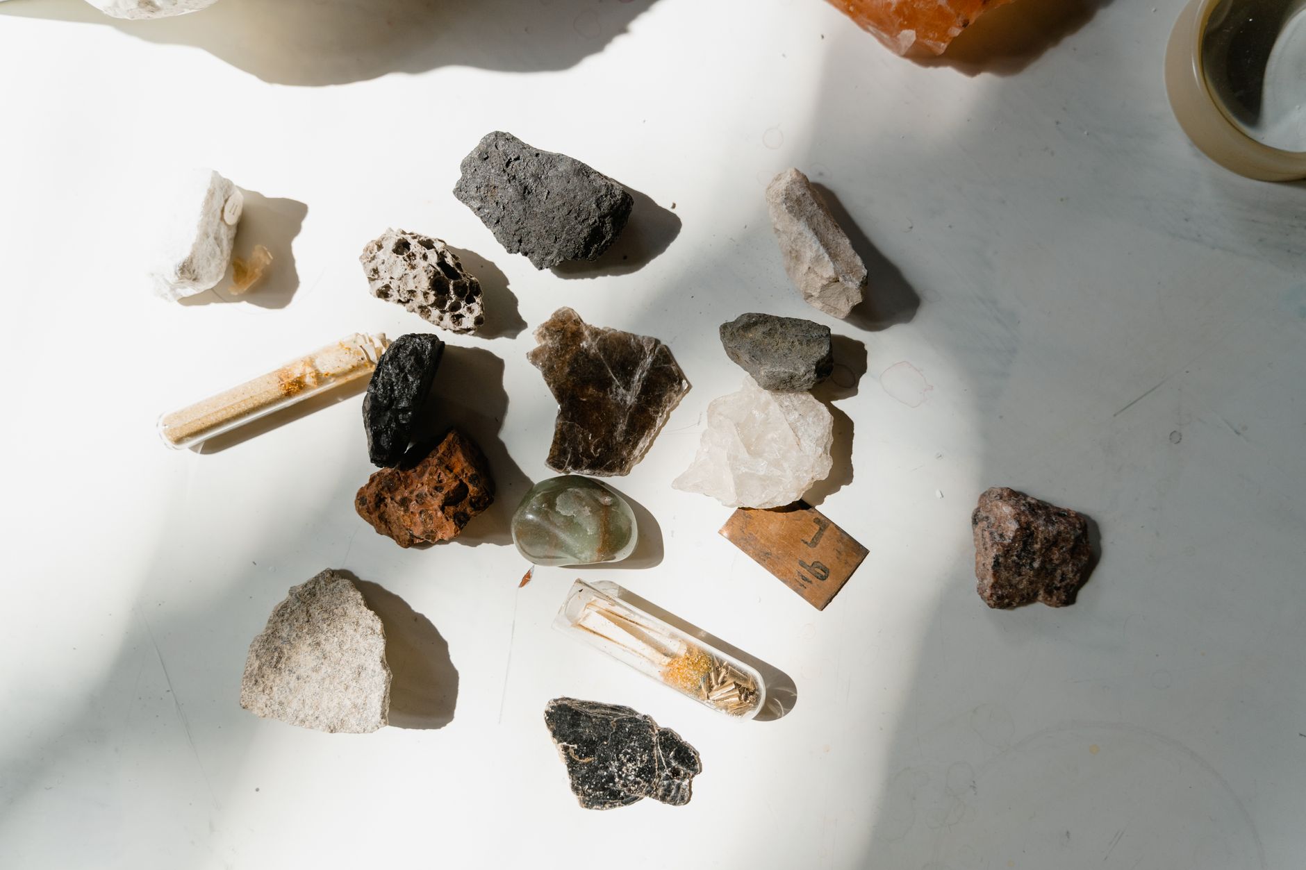Various minerals and rocks arranged on a sunlit table, showcasing natural textures and colors, illustrating What Is Table Rock, and What Is on Top of It