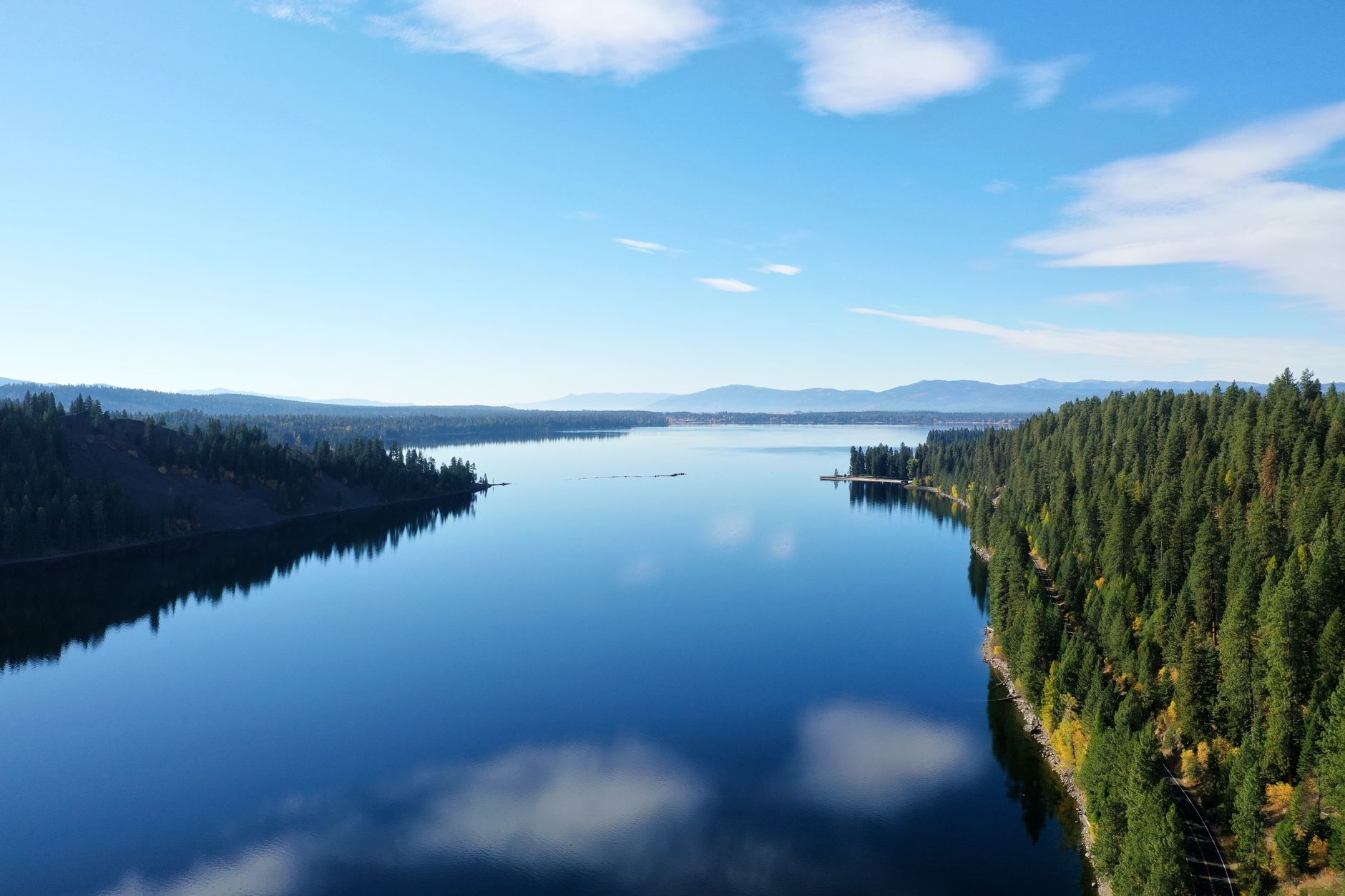 Breathtaking view of a tranquil lake surrounded by lush forests in McCall, Idaho, USA, illustrating What Is McCall, Idaho, and How Far Is It From Boise