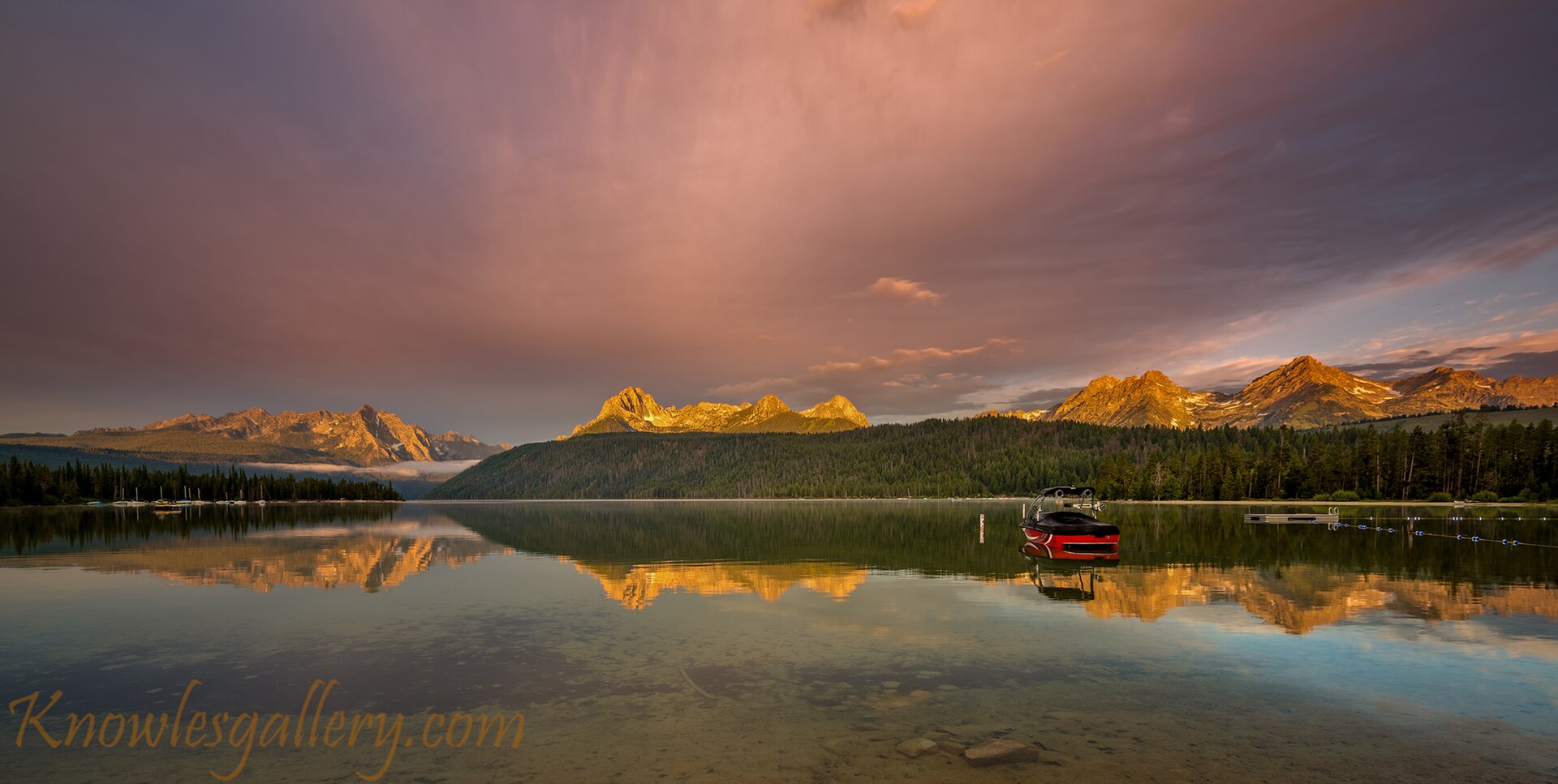 Boat on Redfish lake as the morning light hits the high mountain tops Flickr Knowles Gallery, illustrating What Is Redfish Lake, Idaho? A Straight Answer