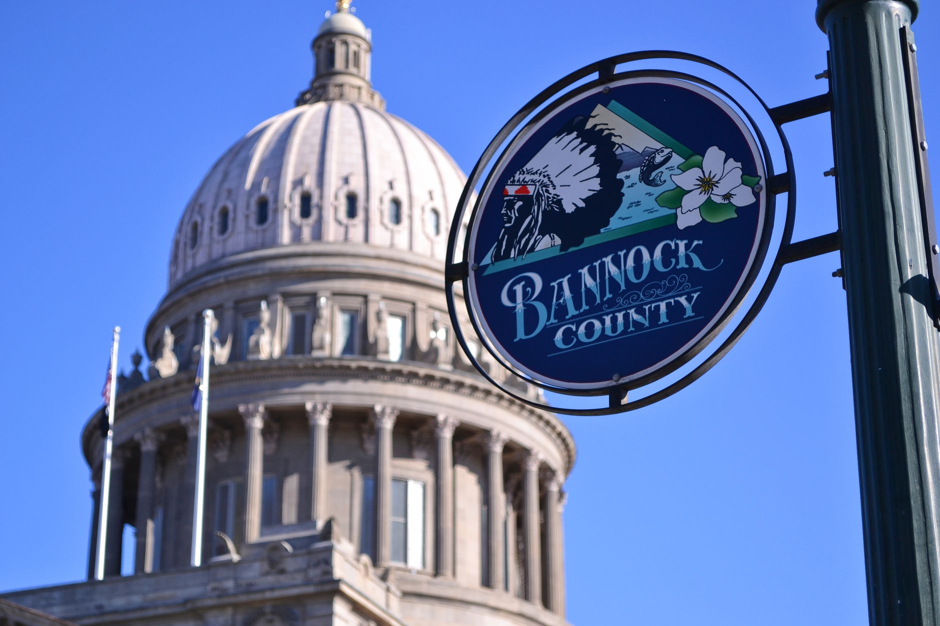 Idaho State Capitol Building dome with Bannock County sign under a clear blue sky in Boise, illustrating Where Do Boise's Food Trucks Gather? A Straight Answer
