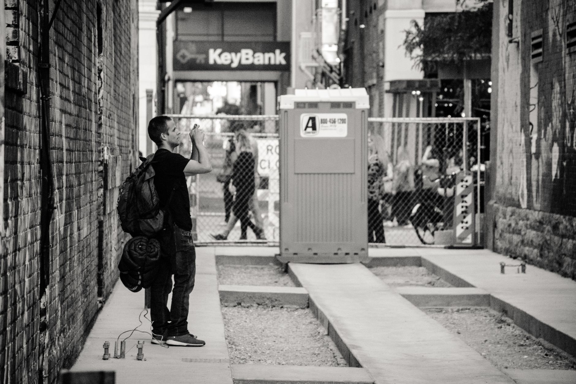 A street photographer in Boise, ID captures a candid urban scene with a city backdrop, illustrating Which Boise Museums Are Free, and When? A Practical Guide